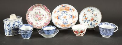 many different types of porcelain dishes and cups on the table