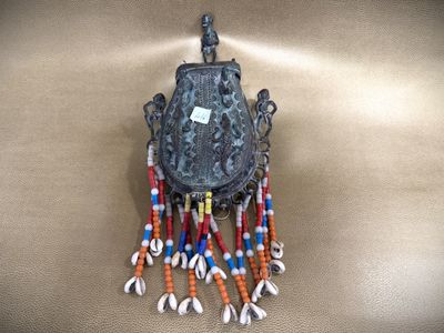 a small metal object with beads hanging from it ' s back