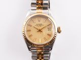 an image of a gold and silver wrist watch with roman numerals