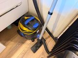 a vacuum that is sitting on the floor next to a wall