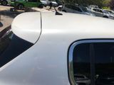 a white car parked in a parking lot with other cars in the background
