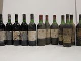 several bottles of wine are lined up in a row on a table