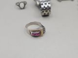 a silver ring with a pink stone in it