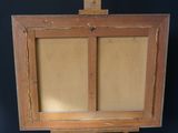 an old wooden easel with a piece of paper on top of it