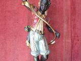 a statue of a man holding a torch in his hand