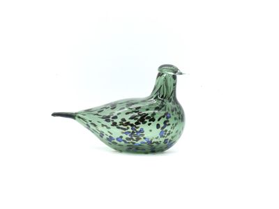 a glass bird that is sitting on a white surface
