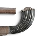 a gun that is laying on a white surface