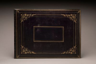 a black and gold photo album with a picture frame