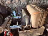 a pile of luggage sitting on top of a wooden box