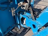 an image of a blue dump truck parked in a parking lot