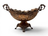 an ornate bronze bowl on stand on a white background