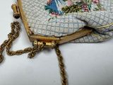 a small purse with a chain hanging from it ' s side