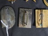 several metal objects are displayed on a black surface