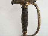a gold sword with a black handle on a white background