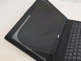 a black laptop with a black keyboard on a white table