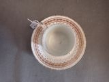 a small cup and saucer sitting on a table