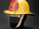 a close up of a yellow fire helmet with a number on it