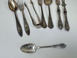 a lot of silver spoons and forks on the table
