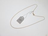 a close up of a necklace with a tag attached to it