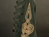 a green military jacket with a gold embroidered design on it