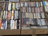 a lot of dvds in a box on the floor