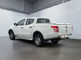 a picture of a white truck parked in a garage