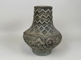 a vase that is sitting on a white surface