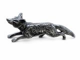 un gros plan d'une figurine d'animal en métal sur fond blanc