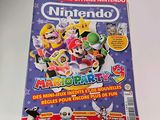 the front cover of a magazine with a picture of mario and friends on it