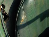 a close up of a green leather seat in the back of a car