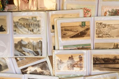 a lot of old photos on display on a table