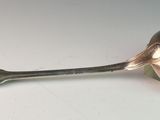 a spoon with a spoon handle on a white surface