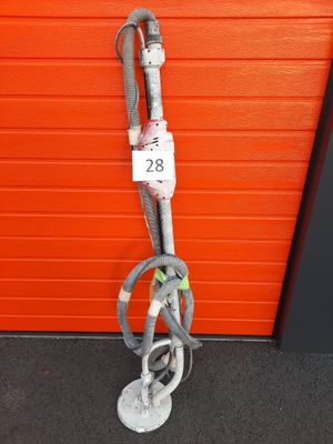 a close up of a hose attached to a pole in front of a red wall