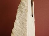 a white sculpture of a crucifix on a wooden table