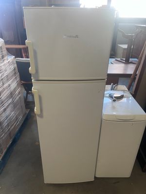 a white refrigerator and freezer sitting in a room