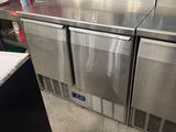 three refrigerators that are sitting in a kitchen
