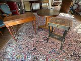 two tables and two chairs in a room with a rug on the floor