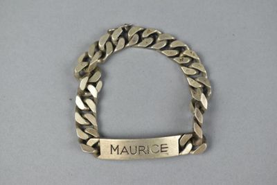 an image of a gold bracelet with a name engraved on it