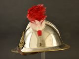 a silver helmet with a red feather on top of it