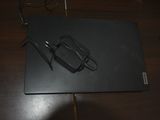 a black laptop with a pair of glasses on top of it