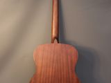 a close up of an acoustic guitar on a gray background