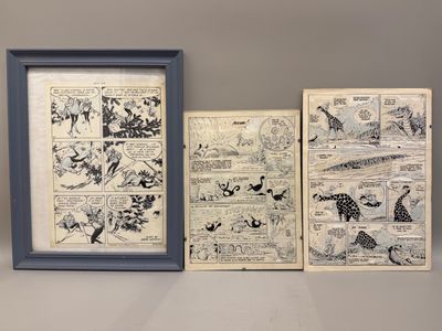 Trois bandes dessinées encadrées sont posées sur une étagère près d'un mur.