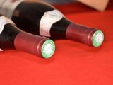 two bottles of wine sitting on a red table