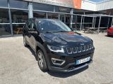 the jeep compass is parked in front of a building