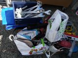 a cart full of tools and other items on the ground