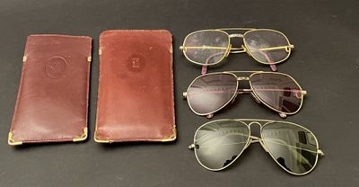 three pairs of sunglasses, a case and a pair of glasses