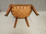 an image of a wooden chair with a leather seat and legs