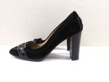 black high heeled pumps with tassels on the toes