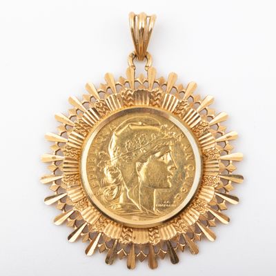 a close up of a gold medal with a woman ' s face on it
