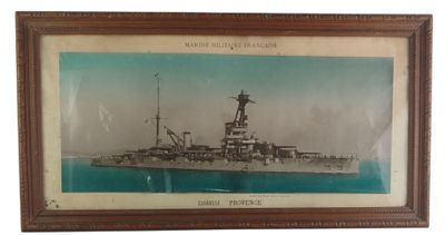 an old picture of a battleship in a frame on a wall